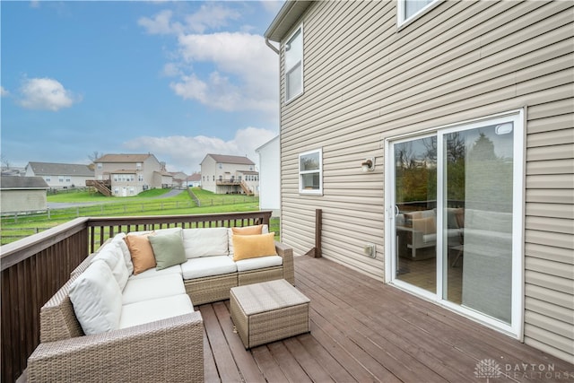 wooden terrace with outdoor lounge area and a lawn