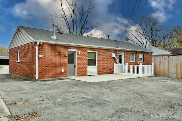 back of property with a patio