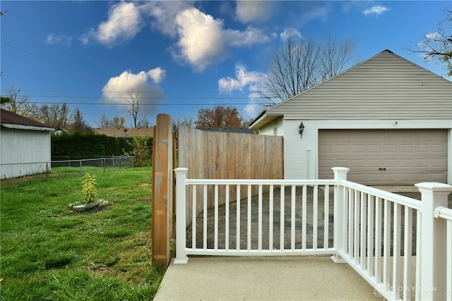 view of yard with a garage and an outbuilding