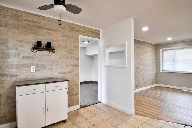 kitchen featuring ceiling fan, light hardwood / wood-style flooring, white cabinets, and tile walls