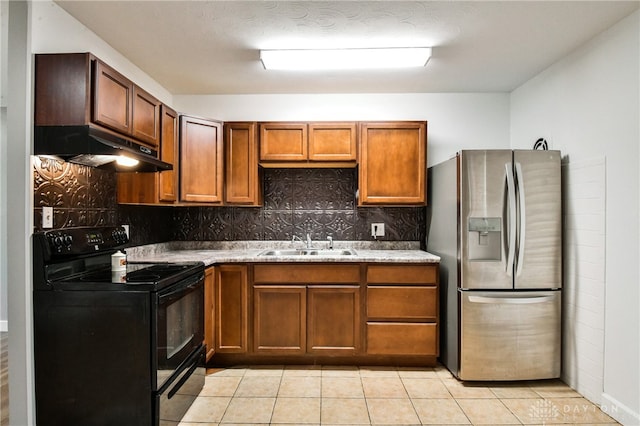 kitchen with electric range, sink, stainless steel refrigerator with ice dispenser, decorative backsplash, and light tile patterned floors