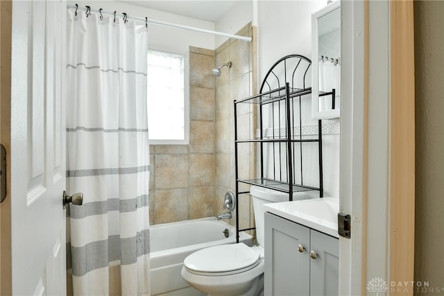 full bathroom with shower / tub combo with curtain, vanity, and toilet