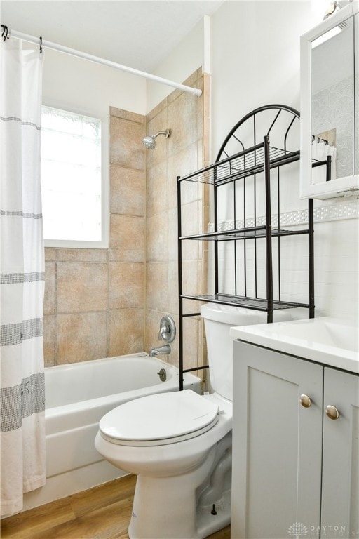 full bathroom featuring wood-type flooring, vanity, toilet, and shower / bathtub combination with curtain