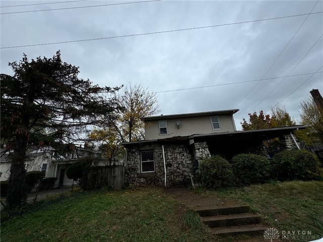 view of home's exterior featuring a lawn and a carport