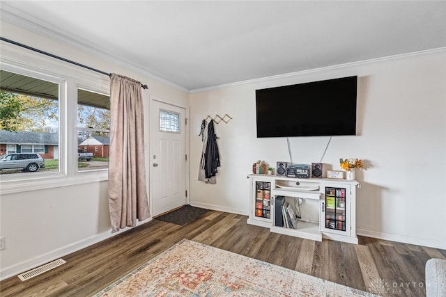 entrance foyer with dark hardwood / wood-style floors and ornamental molding