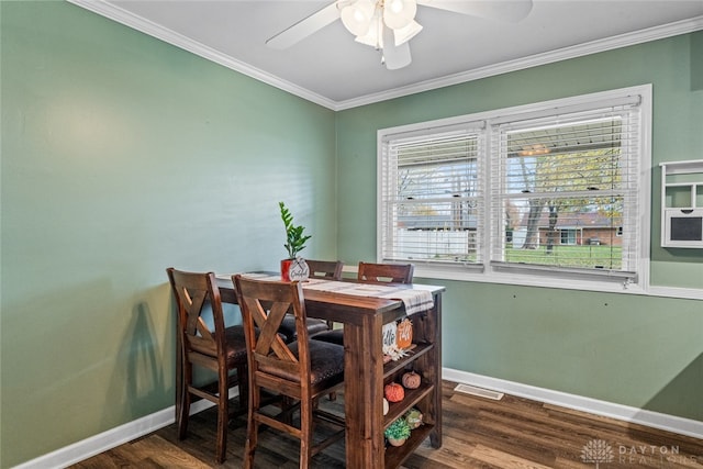 dining space with ceiling fan, dark hardwood / wood-style flooring, and ornamental molding