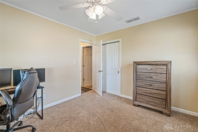 carpeted home office featuring ceiling fan and ornamental molding