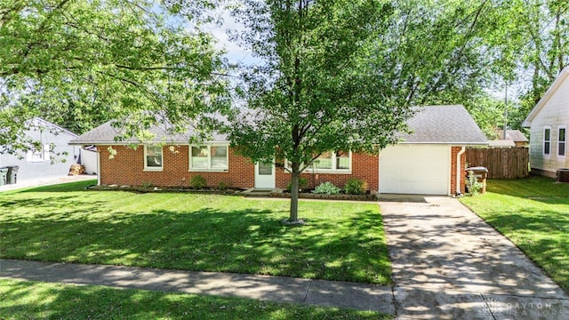 ranch-style house featuring a front yard, a garage, and central AC unit