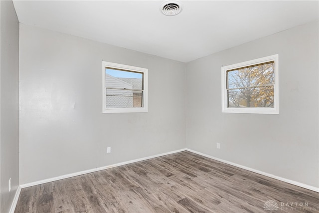 spare room featuring hardwood / wood-style floors and a wealth of natural light