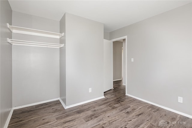 unfurnished room with hardwood / wood-style flooring