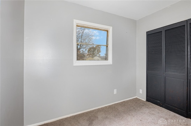 unfurnished bedroom featuring carpet and a closet