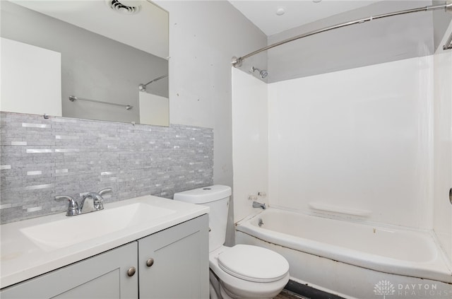 full bathroom with washtub / shower combination, decorative backsplash, vanity, and toilet