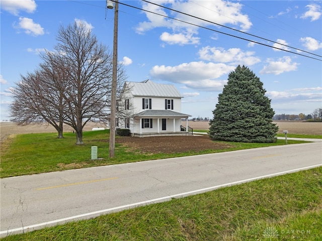 view of front of property with a rural view and a front yard