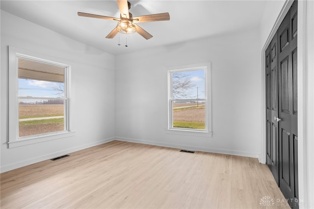 spare room with ceiling fan and light hardwood / wood-style floors