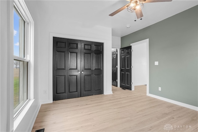 unfurnished bedroom with ceiling fan and light hardwood / wood-style floors