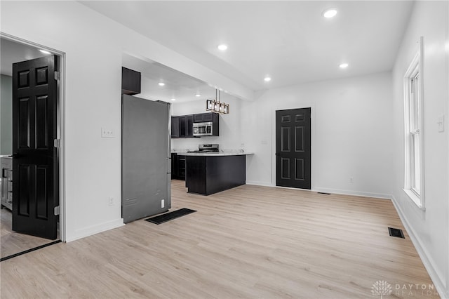 kitchen featuring appliances with stainless steel finishes and light hardwood / wood-style floors