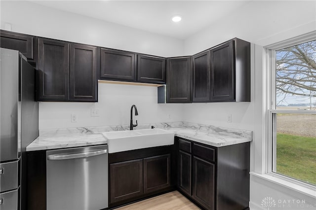 kitchen featuring sink, stainless steel appliances, plenty of natural light, and light hardwood / wood-style flooring