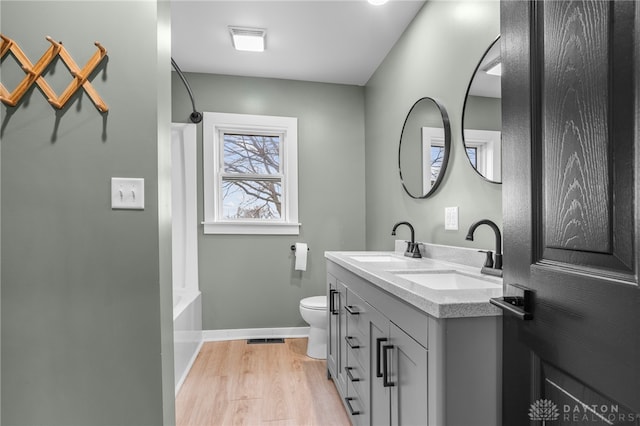 full bathroom featuring toilet, vanity, shower / bath combination, and hardwood / wood-style flooring