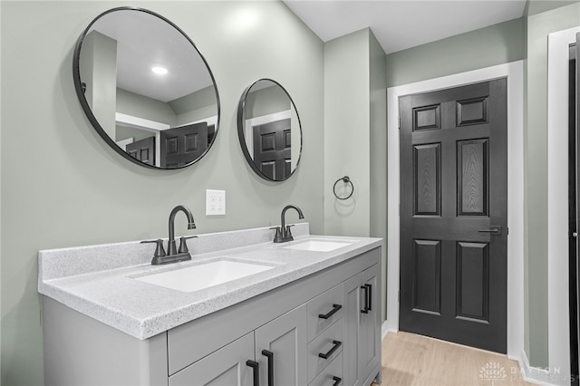 bathroom with hardwood / wood-style flooring and vanity