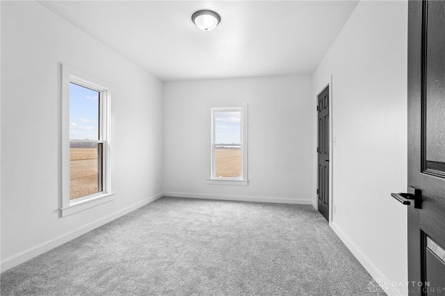 spare room with carpet and plenty of natural light