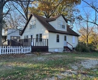 rear view of property with a wooden deck