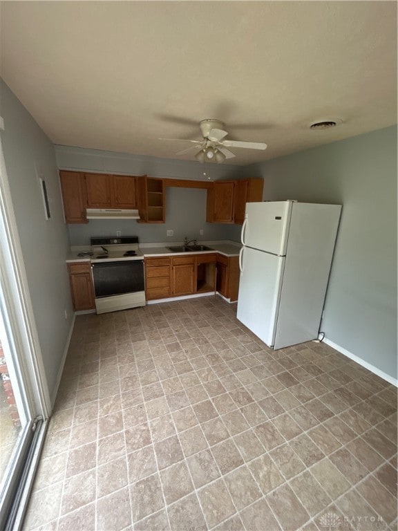 kitchen with ceiling fan, sink, and white appliances