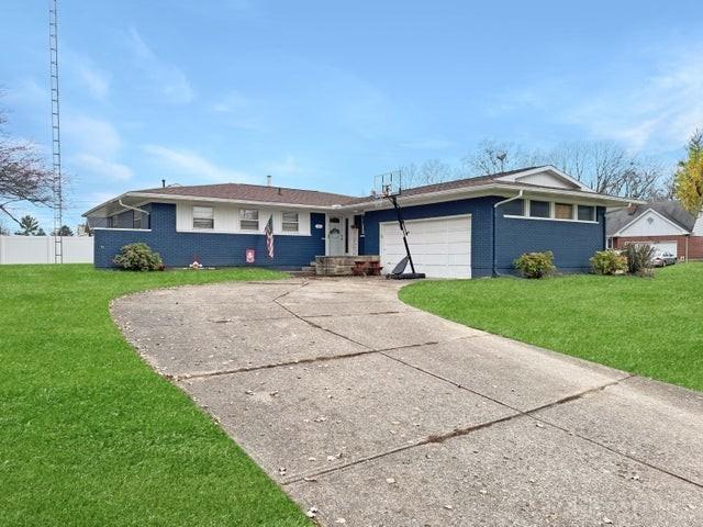 ranch-style home with a front yard and a garage