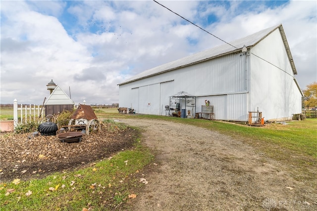 view of property exterior with an outdoor structure