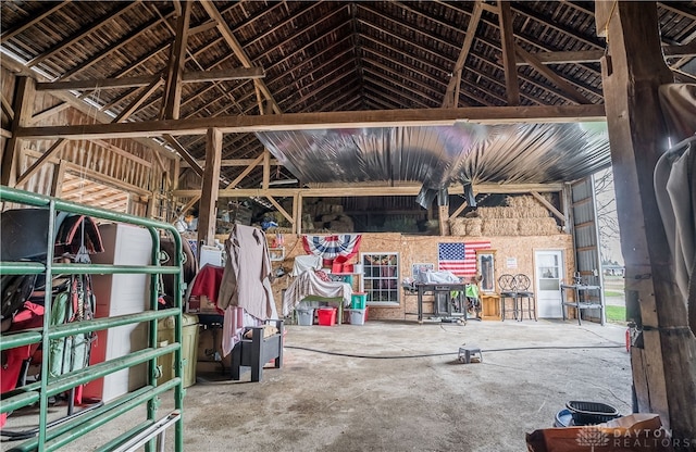 miscellaneous room featuring lofted ceiling and concrete floors