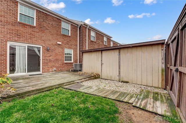 back of property with central AC and a wooden deck