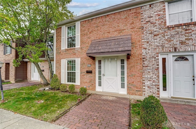 entrance to property with a lawn