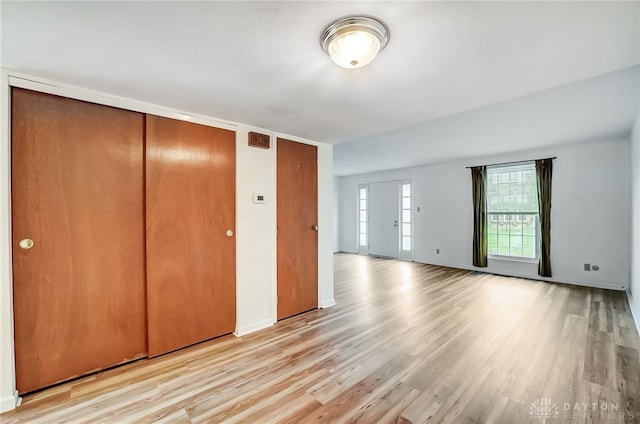 unfurnished bedroom with light wood-type flooring