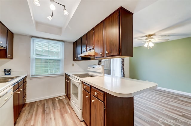 kitchen featuring ceiling fan, sink, light hardwood / wood-style flooring, kitchen peninsula, and white appliances