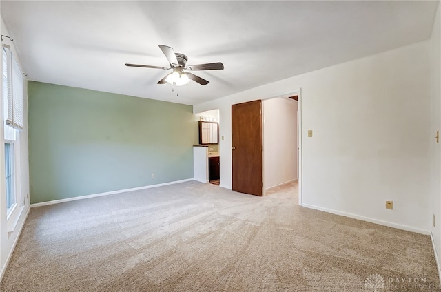 unfurnished room with ceiling fan and carpet floors