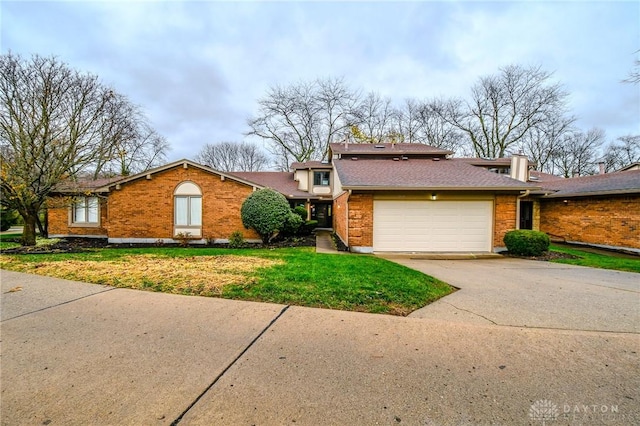 view of front facade featuring roof with shingles, concrete driveway, a front yard, a garage, and brick siding