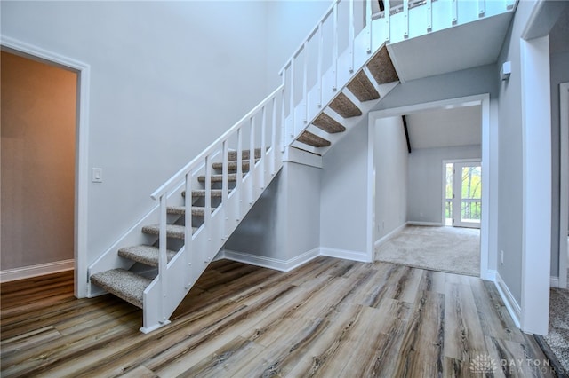 stairs with hardwood / wood-style flooring