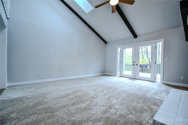 unfurnished living room with baseboards, french doors, carpet floors, high vaulted ceiling, and beam ceiling