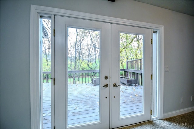 doorway to outside featuring carpet flooring and french doors