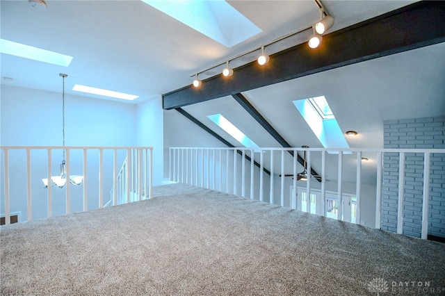 bonus room with lofted ceiling with beams and carpet