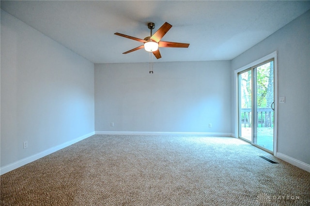 carpeted spare room featuring ceiling fan