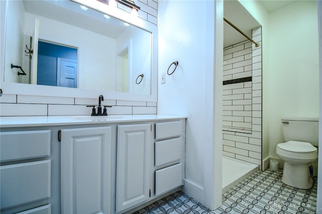 bathroom with toilet, a stall shower, and vanity