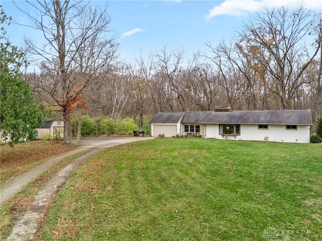 view of front of property with a front lawn and a garage