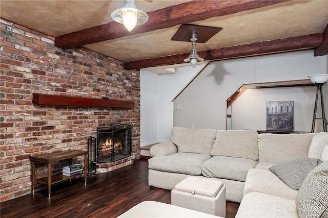 living room with hardwood / wood-style flooring, beam ceiling, and a fireplace