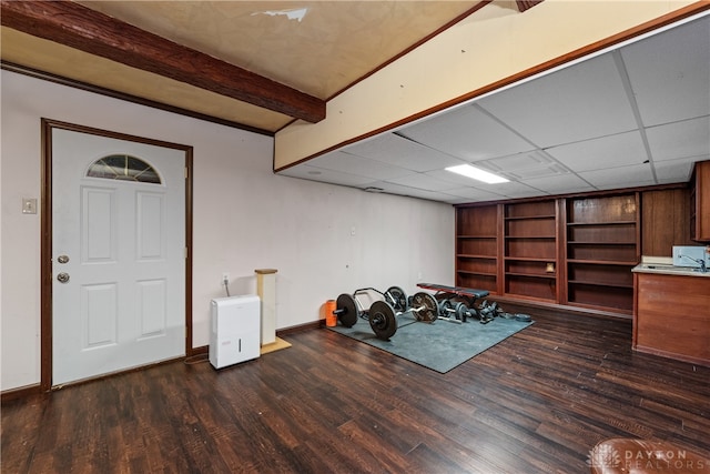 misc room featuring a paneled ceiling and dark hardwood / wood-style flooring