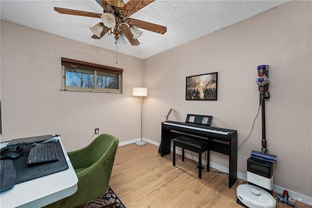 office space with ceiling fan, light hardwood / wood-style floors, and a textured ceiling