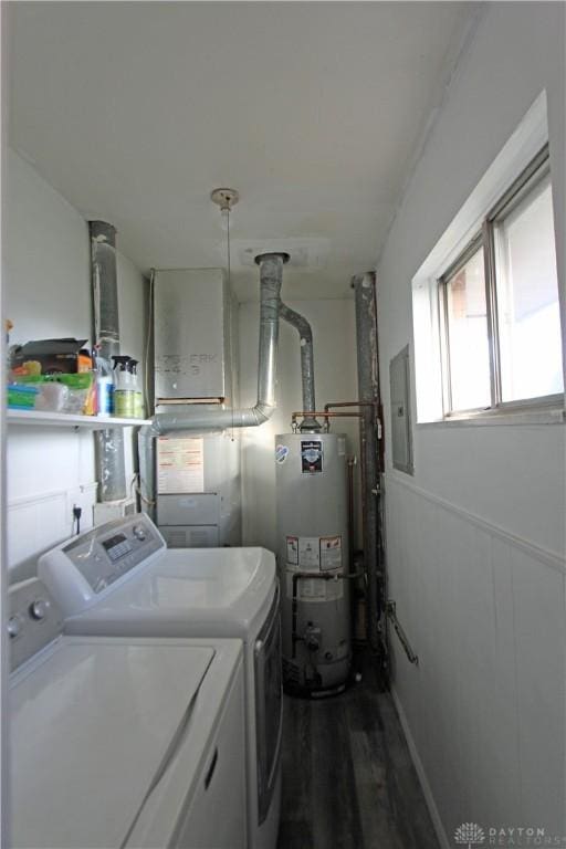 laundry room with water heater, washer and dryer, electric panel, and dark hardwood / wood-style flooring