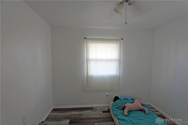 spare room featuring dark hardwood / wood-style floors and ceiling fan