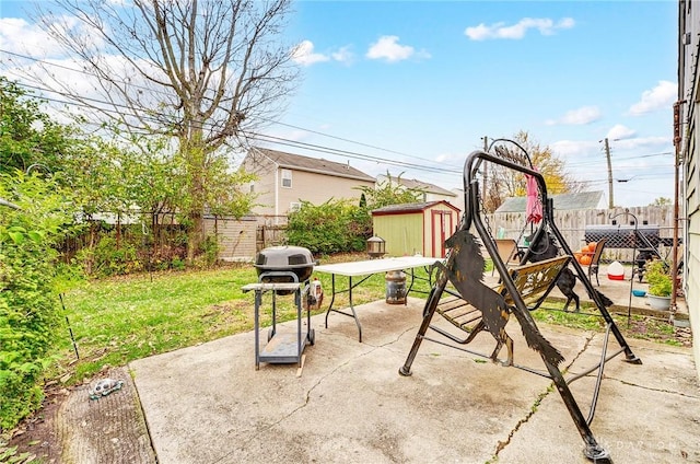 view of patio / terrace featuring a grill, a playground, and a shed