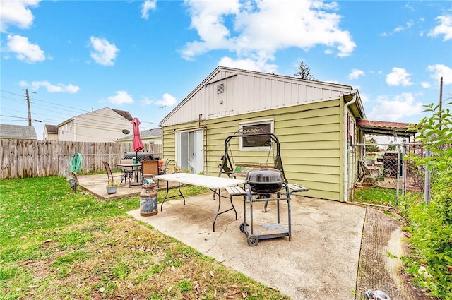 back of house featuring a patio and a yard