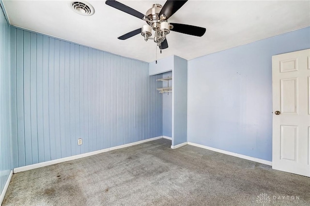 carpeted spare room with ceiling fan